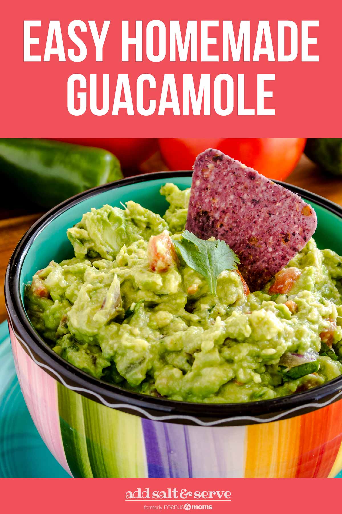 Homemade guacamole in a rainbow-striped bowl, with half an avocado in the background.