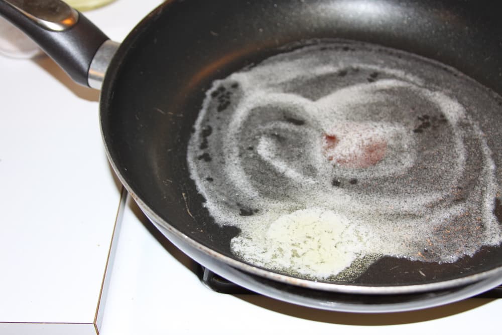 butter melting in a black frypan