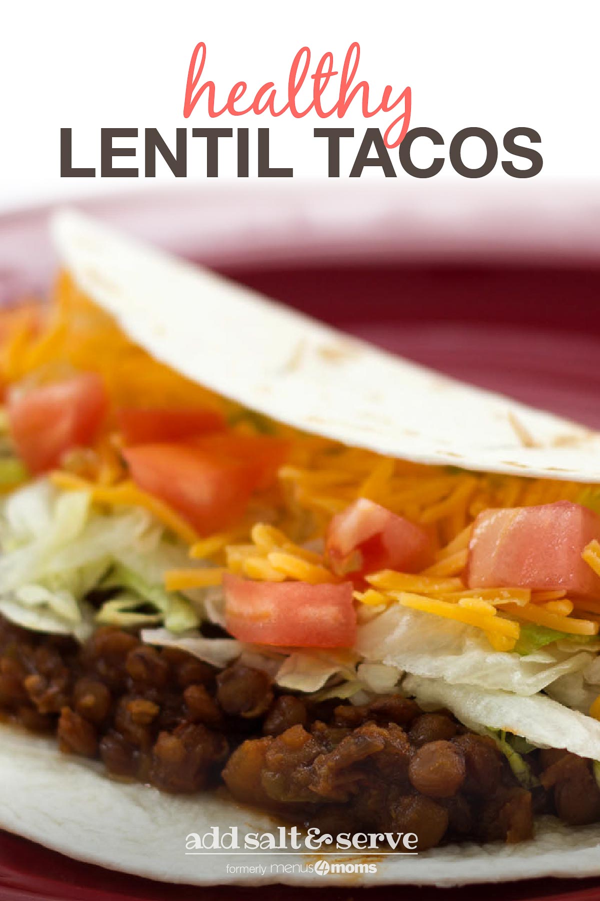 Folded tortilla with lentils, shredded lettuce, diced tomatoes, and shredded cheddar cheese on a red plate.