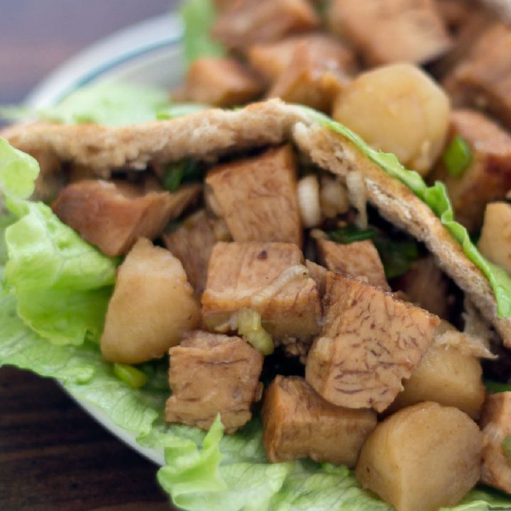 Diced chicken in a lettuce-lined pita on a white plate