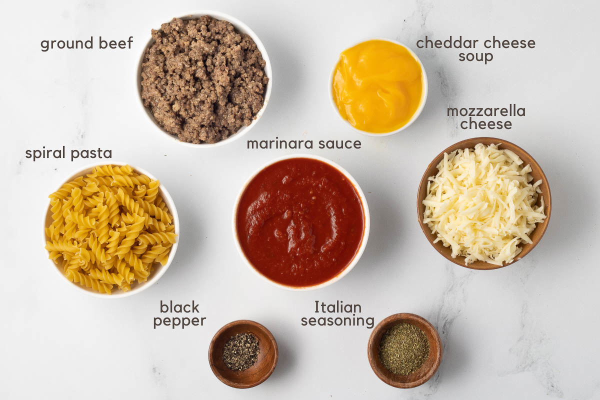 Ingredients for Spiral Pasta recipe: cooked ground beef, spiral pasta, marinara sauce, condensed cheddar cheese soup, shredded mozzarella cheese, Italian seasoning, and black pepper.