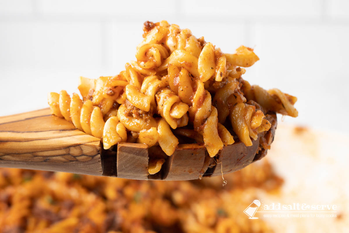 Spiral pasta bake on a wooden spoon.