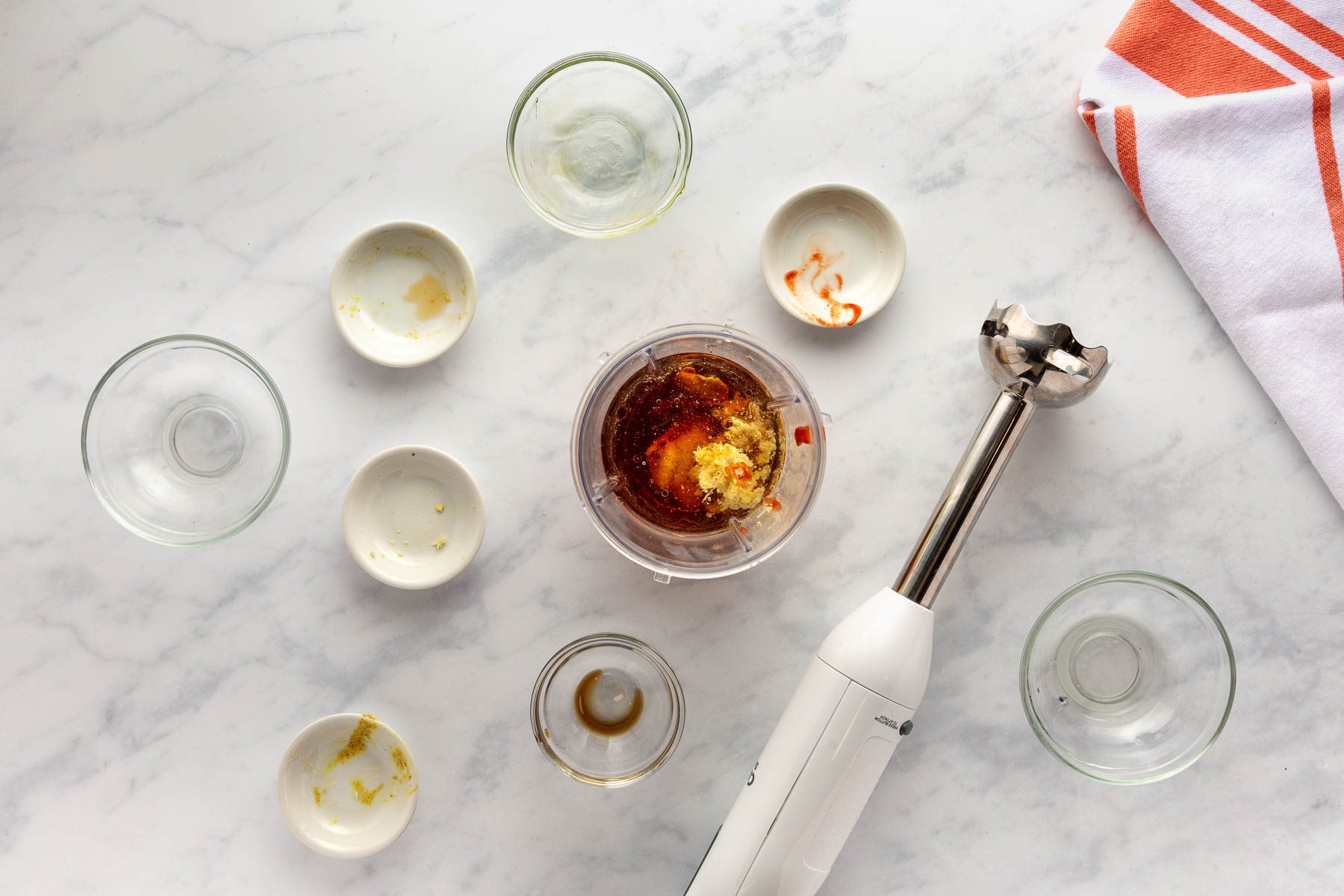 Ingredients for Sesame Ginger Dressing in a container beside an immersion blender before blending.