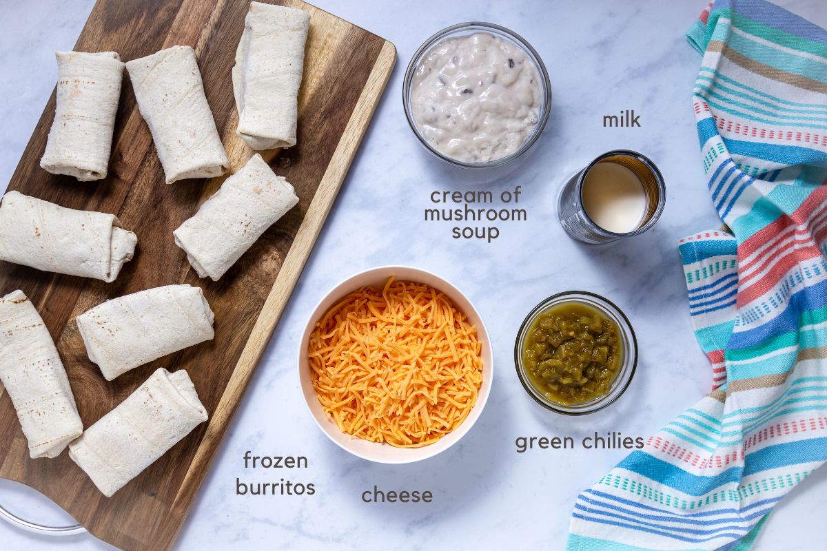 Ingredients for frozen burrito casserole: frozen burritos, condensed cream of mushroom soup, milk, green chilies, and shredded cheddar cheese.