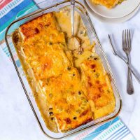 Frozen Burrito Casserole in a baking dish with a serving on a plate beside it and text Burrito Casserole - 5 ingredients!