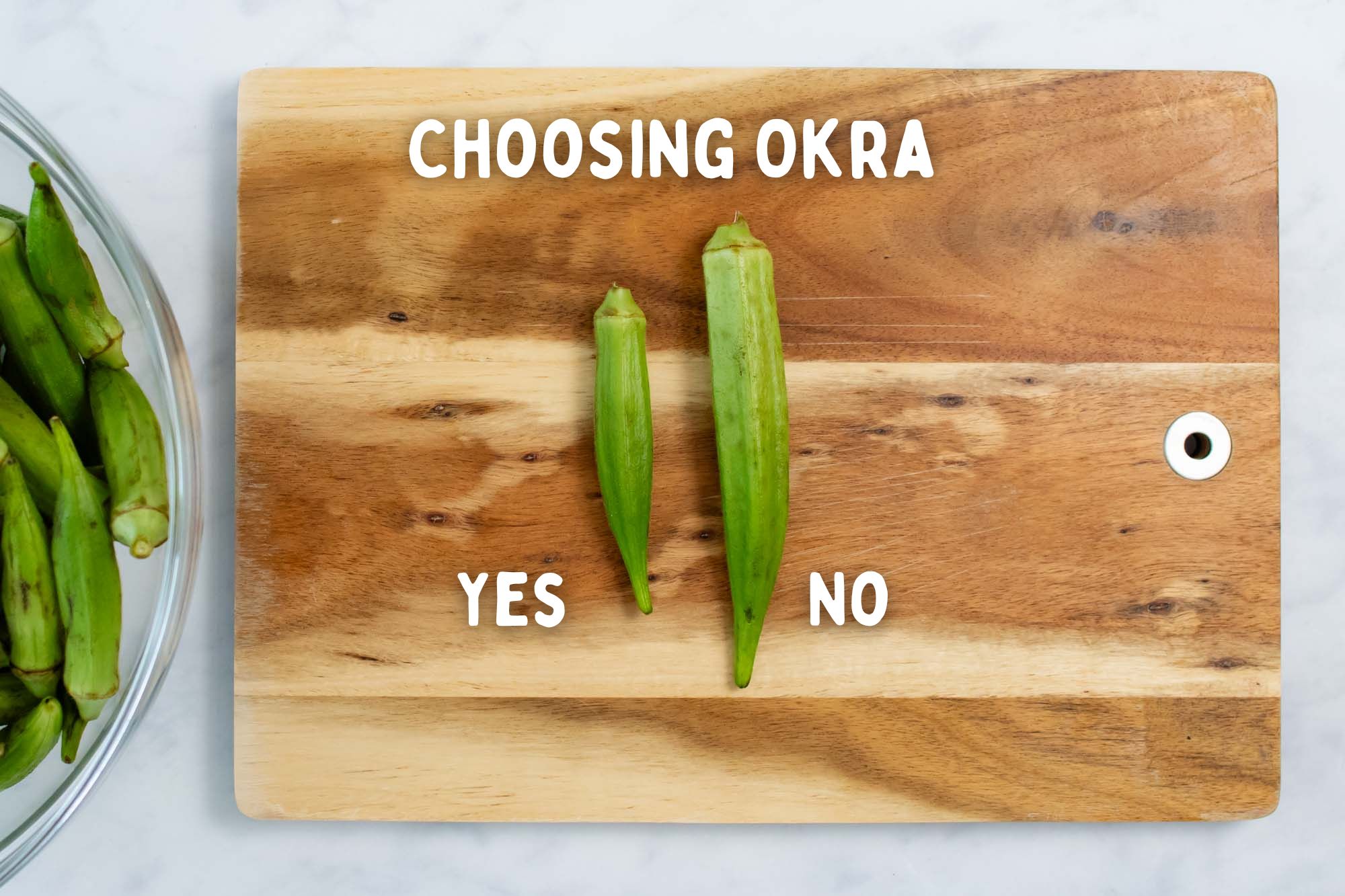 Two pieces of okra on a cutting board with text Choosing Okra; one is long and fat with text No, and one is short and slender with text Yes.