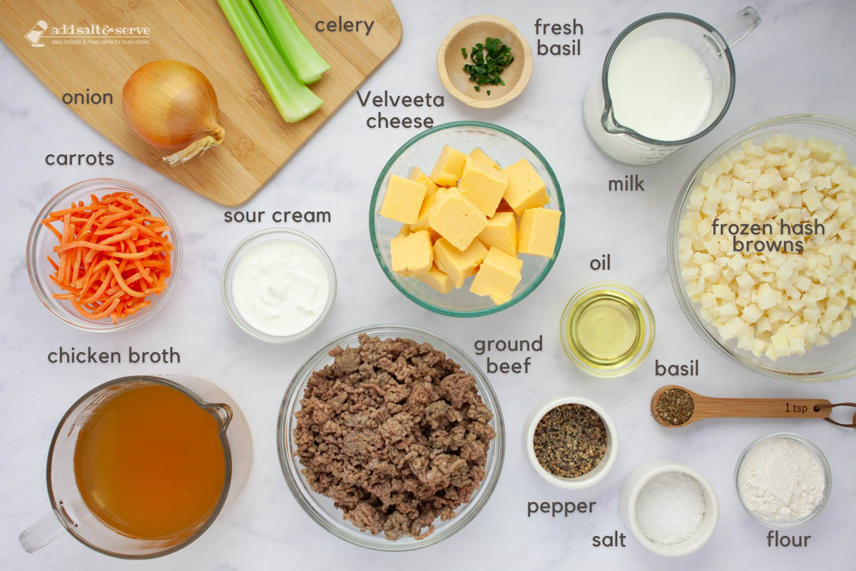 Ingredients for Cheeseburger Soup: onion, celery, shredded carrots, chicken broth, ground, beef, sour cream, Velveeta cheese, fresh basiil strips, milk, oil, frozen hash browns, cooking oil, dried basil, flour, salt, and pepper.