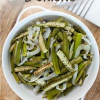 White bowl of roasted okra and onion slices with text Roasted Okra & Onions with text One Pan Roasted Okra & Onions.