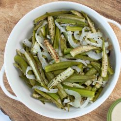 roasted okra and onions in a white bowl.